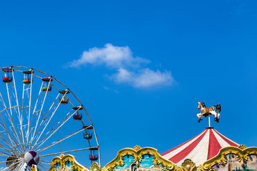 antique carousel horses tent and ferris wheel in amusement park