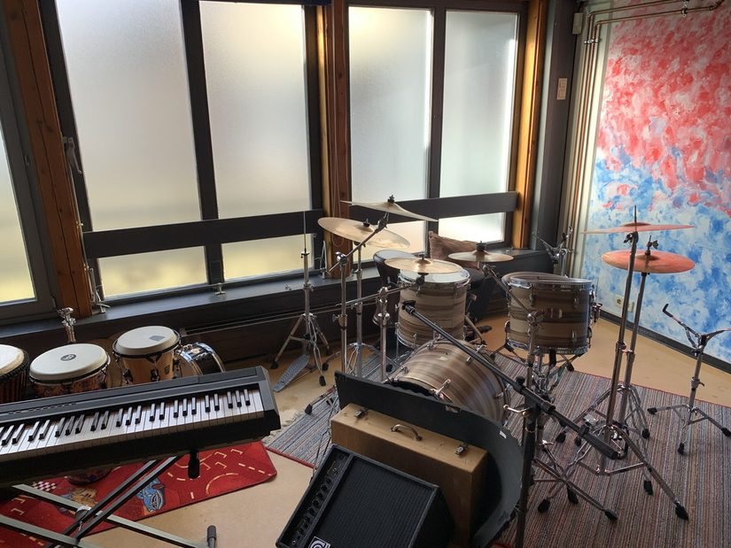 Foto vom Musikraum - Hier stehen unterschiedliche Musikinstrumente wie z.B. ein Schlagzeug, ein keyboard und afrikanische Trommeln.